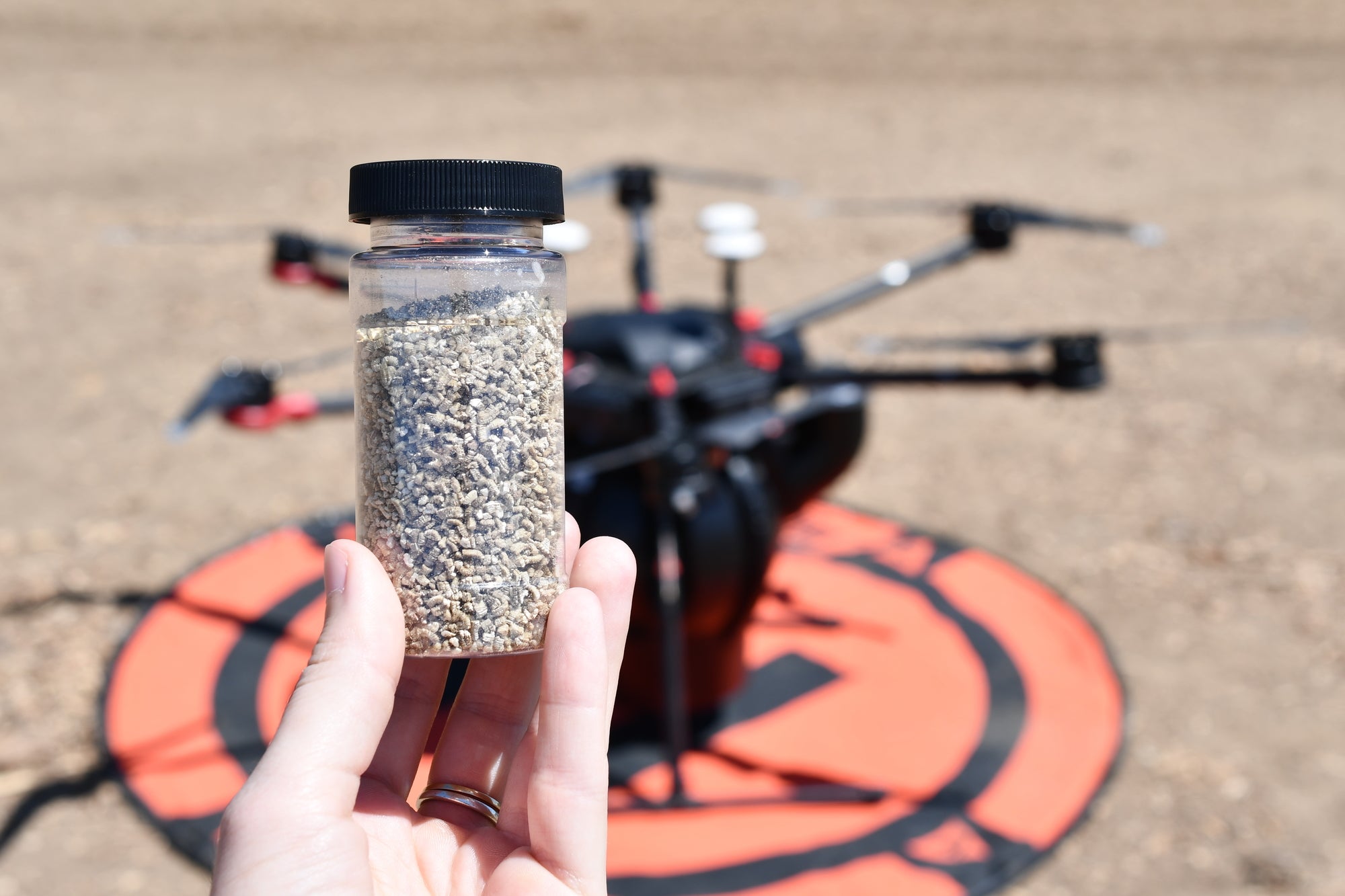 A jar of the predatory spider mite next to the drone