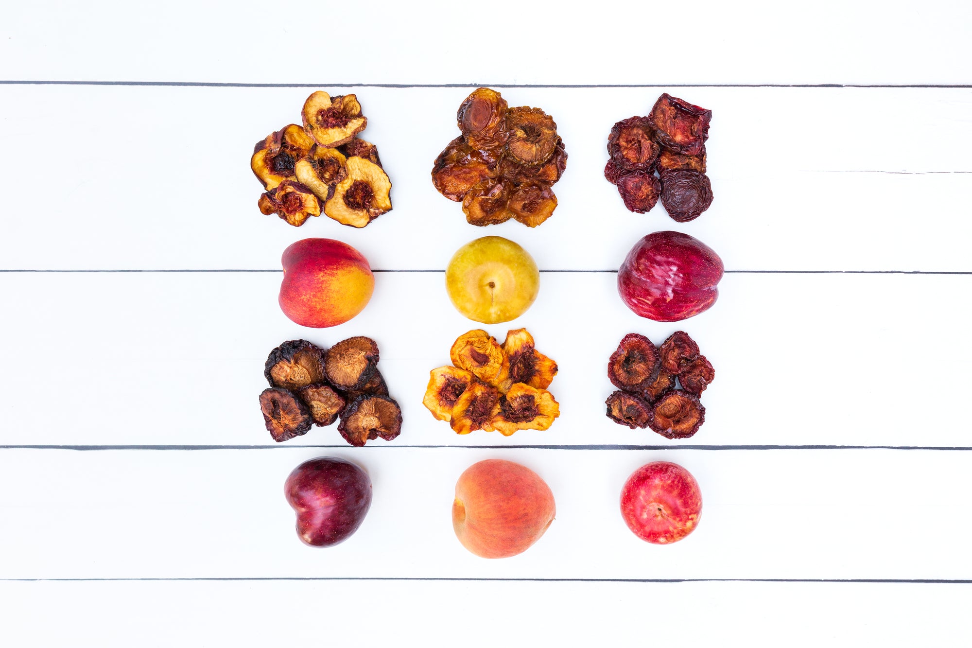 Multiple dried fruit varieties next to their fresh counterparts